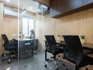 Glass-partitioned private cabin with desk, chairs and air conditioning at Linked Offices, Kolkata